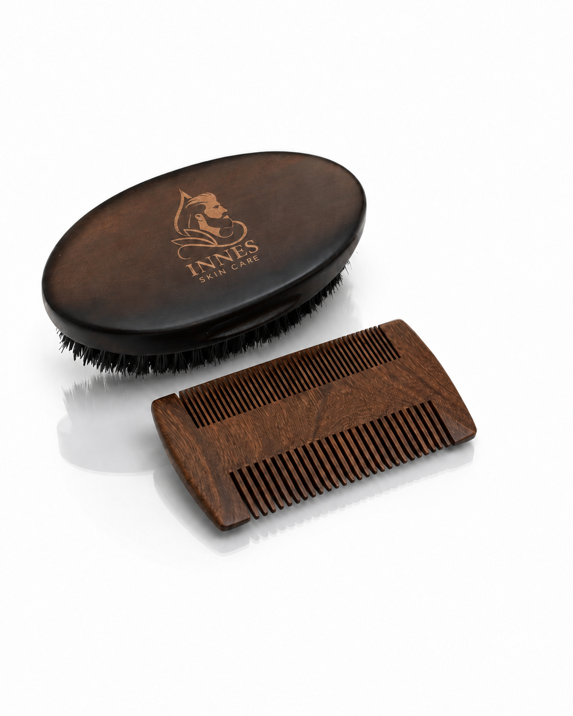 Innes Skin Care wooden beard brush and dual-sided beard comb on a white reflective surface