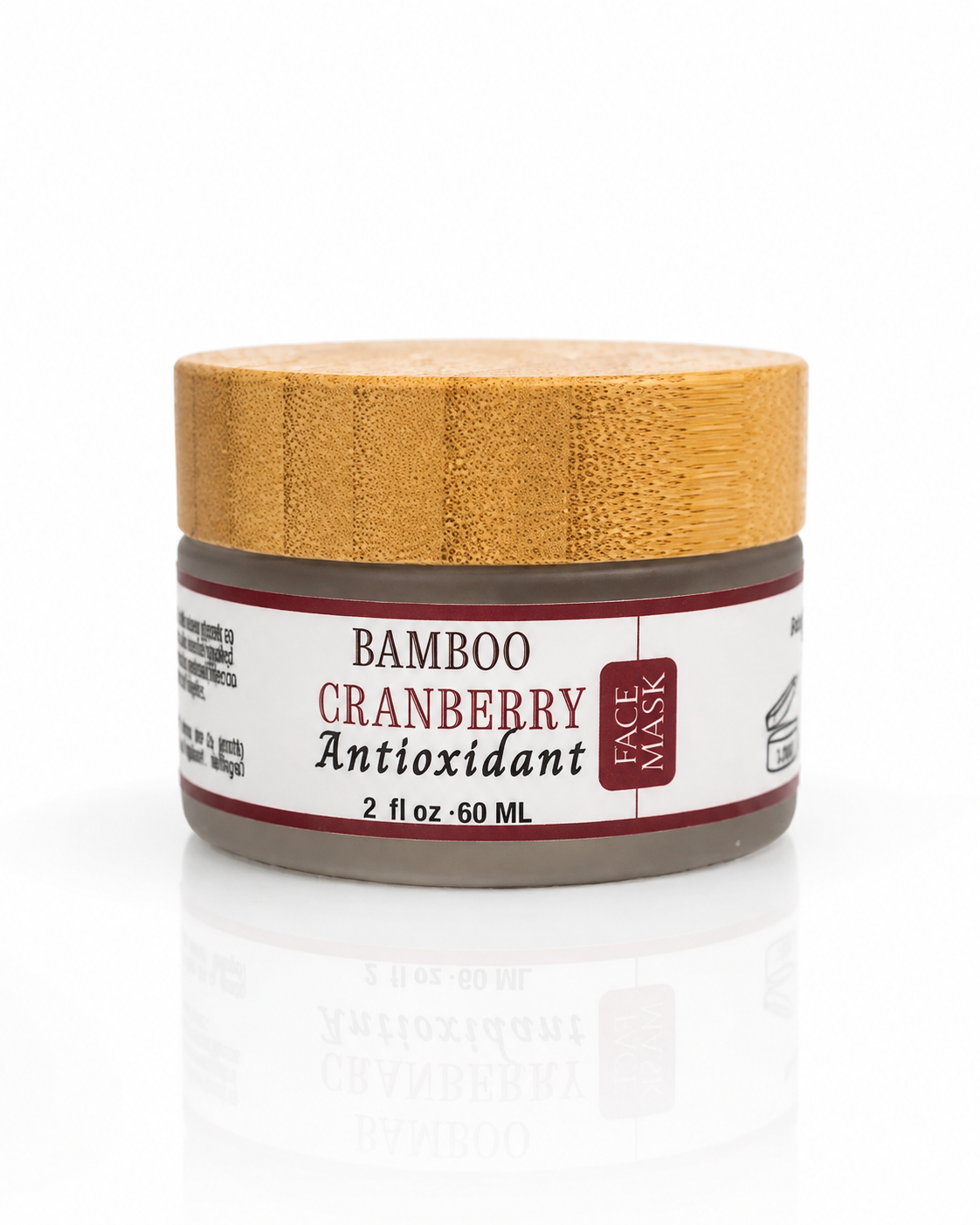 Innes Ageless Beauty Bamboo Cranberry Antioxidant Face Mask in a 2 fl oz jar with a natural bamboo lid on a white reflective background