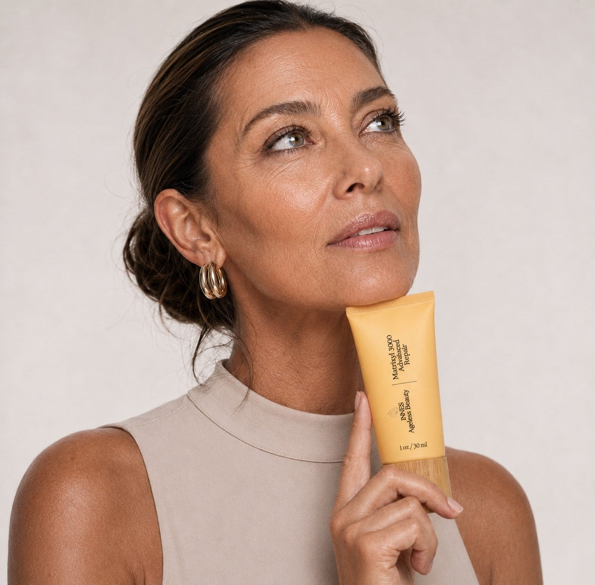 Mature woman holding Innes Ageless Beauty Matrixyl 3000 Advanced Wrinkle Repair Cream