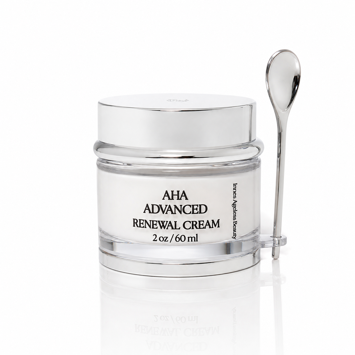 Innes Ageless Beauty AHA Advanced Renewal Cream in a 2 oz silver jar with a cosmetic spatula on a white reflective background