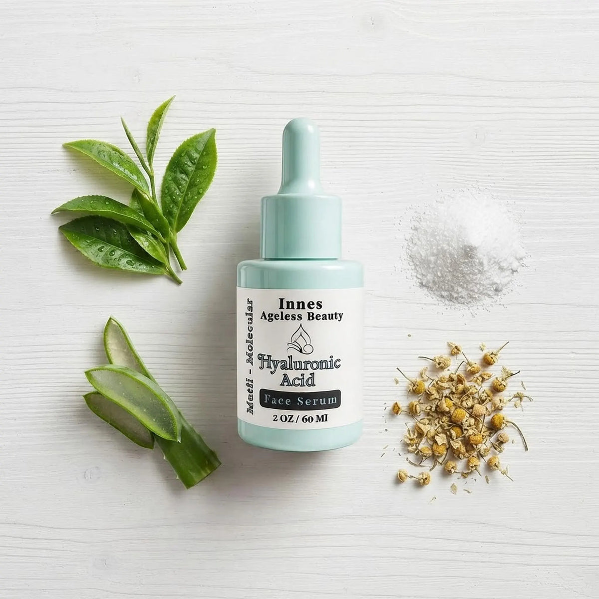 Flat lay of Innes Ageless Beauty face serum surrounded by its natural ingredients including aloe vera, green tea, and chamomile.