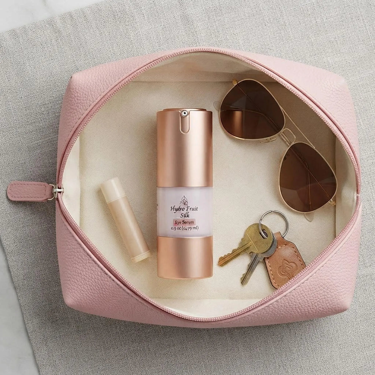 Hydro Fruit Silk Eye Serum bottle inside a cosmetic travel pouch from above.
