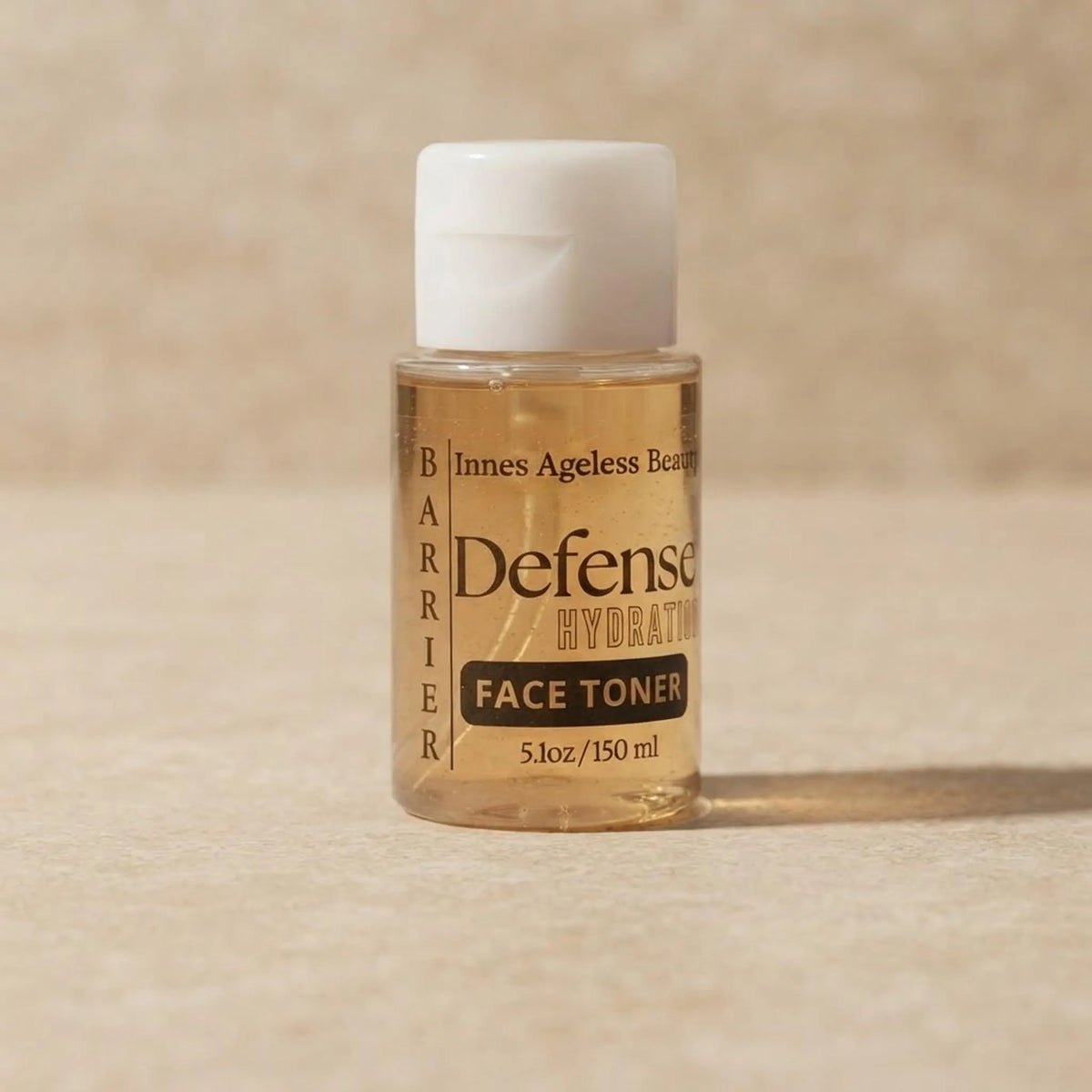 Close-up of the Barrier Defense Hydrating Toner label and golden liquid