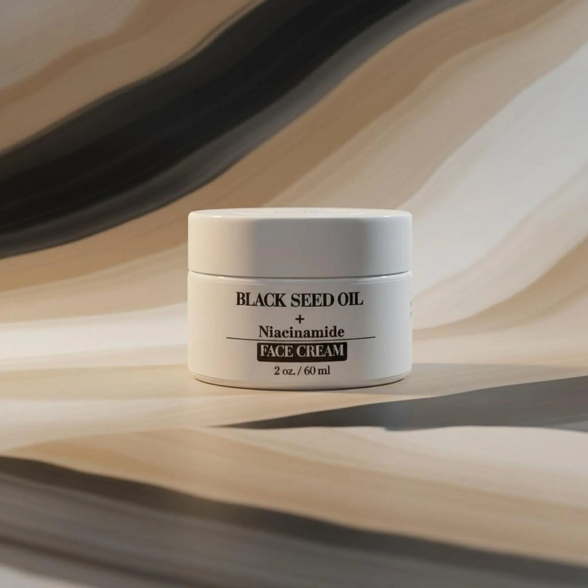 A white cosmetic jar with black text reading BLACK SEED OIL + Niacinamide FACE CREAM on a wavy brown and beige background.