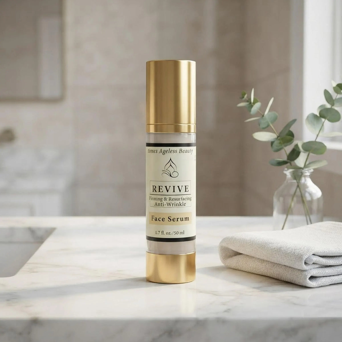 Revive face serum bottle displayed on a white marble vanity next to a white towel and green foliage.