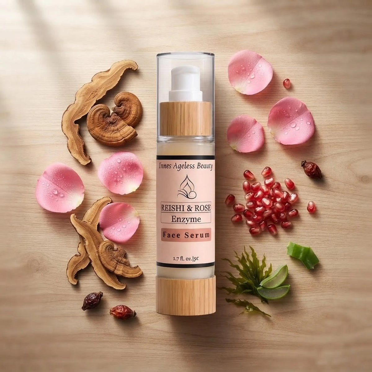 Flat lay of the Innes Ageless Beauty Reishi & Rose Enzyme Face Serum with reishi mushroom, rose petals, and pomegranate seeds