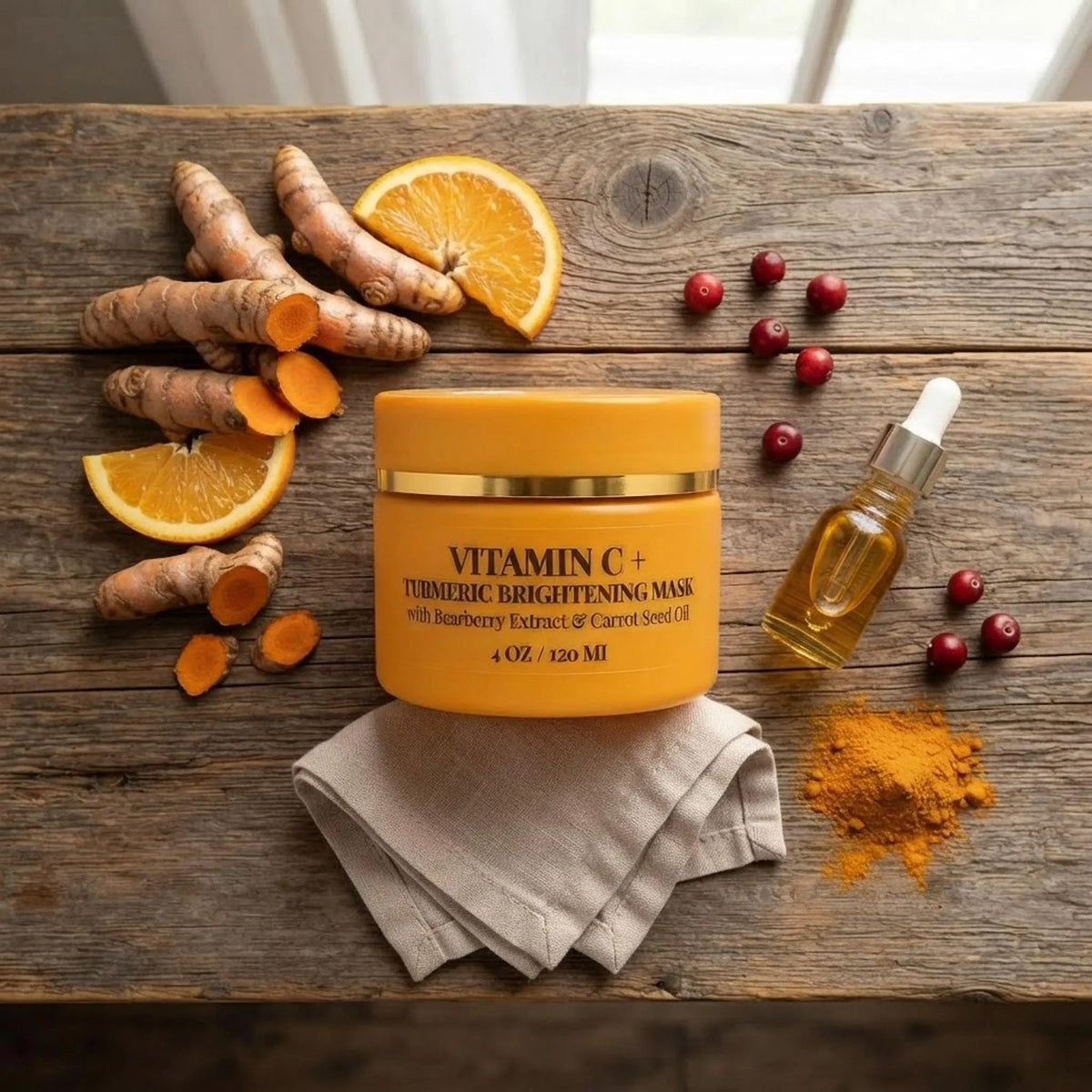 Flat lay of Vitamin C and Turmeric Mask jar with fresh turmeric root and orange slices on wood