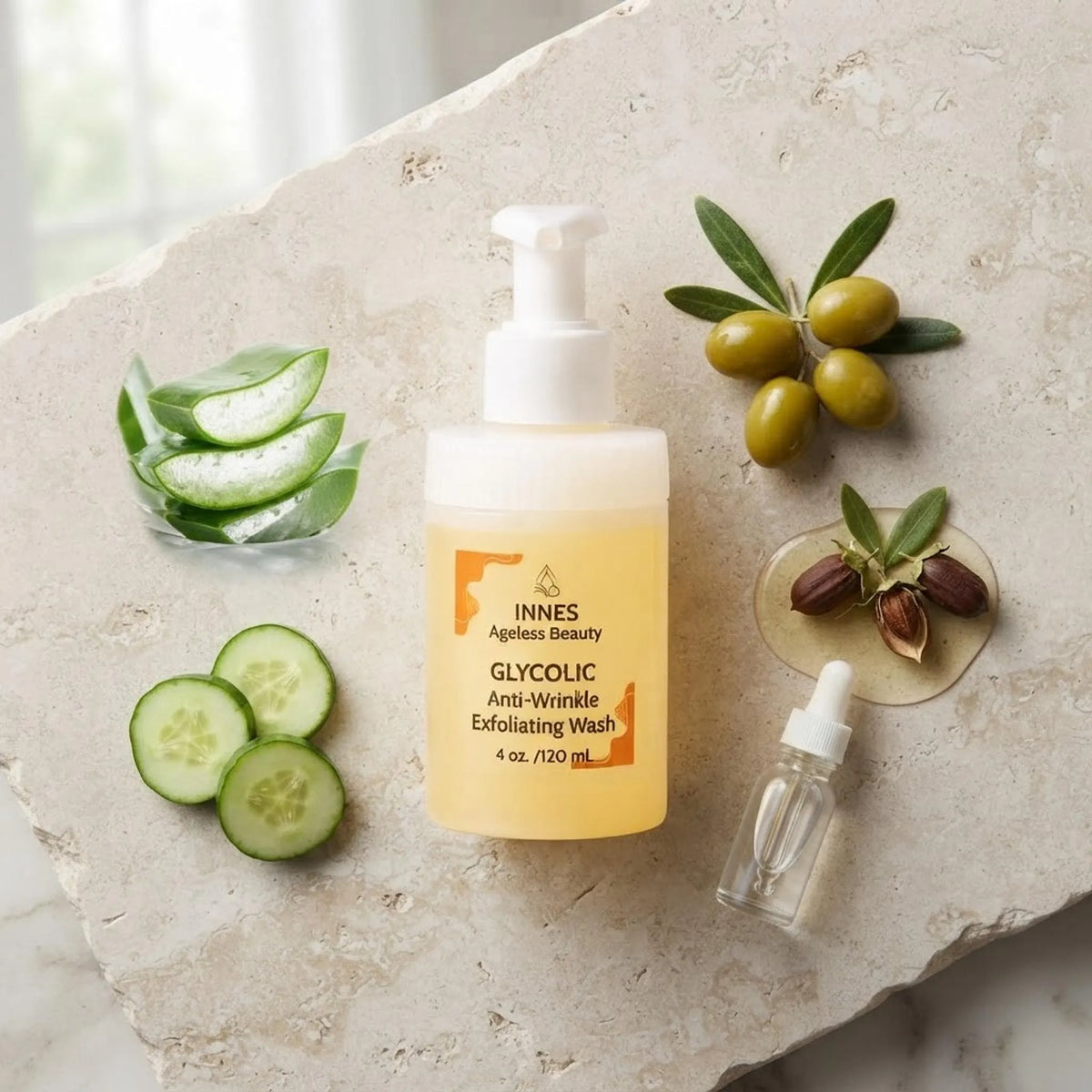 Glycolic Anti-Wrinkle Exfoliating Wash bottle surrounded by natural ingredients like aloe vera, cucumber, and jojoba on a stone background.