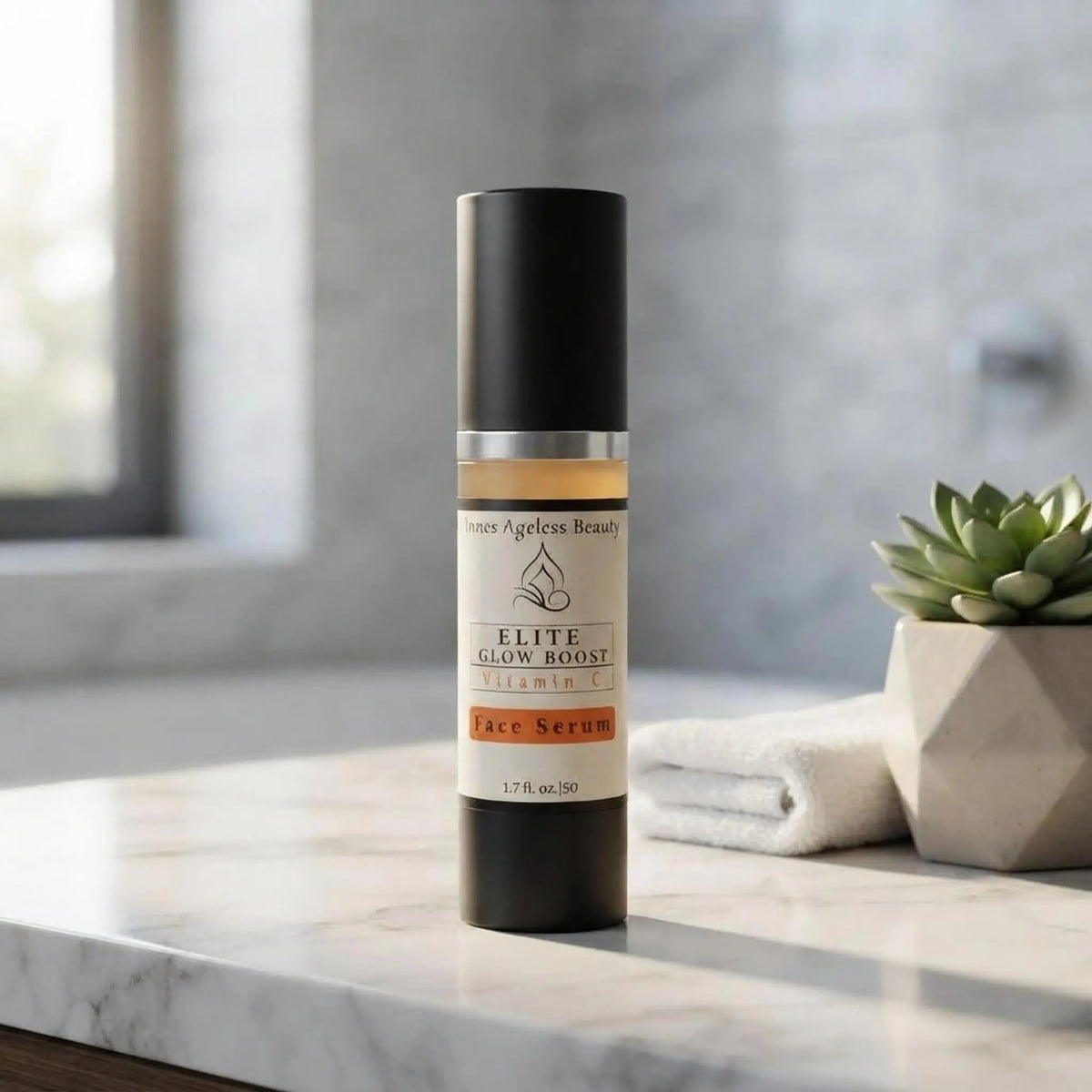 Elite Glow Boost Vitamin C Serum bottle on a modern marble bathroom vanity next to a towel and plant.