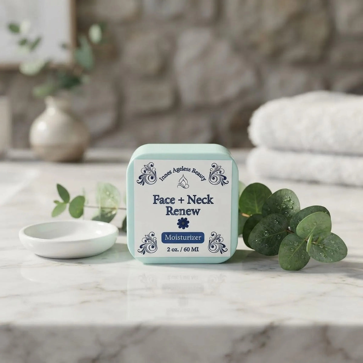 Innes Ageless Beauty Face and Neck Renew Moisturizer jar on a marble bathroom counter with botanical accents.
