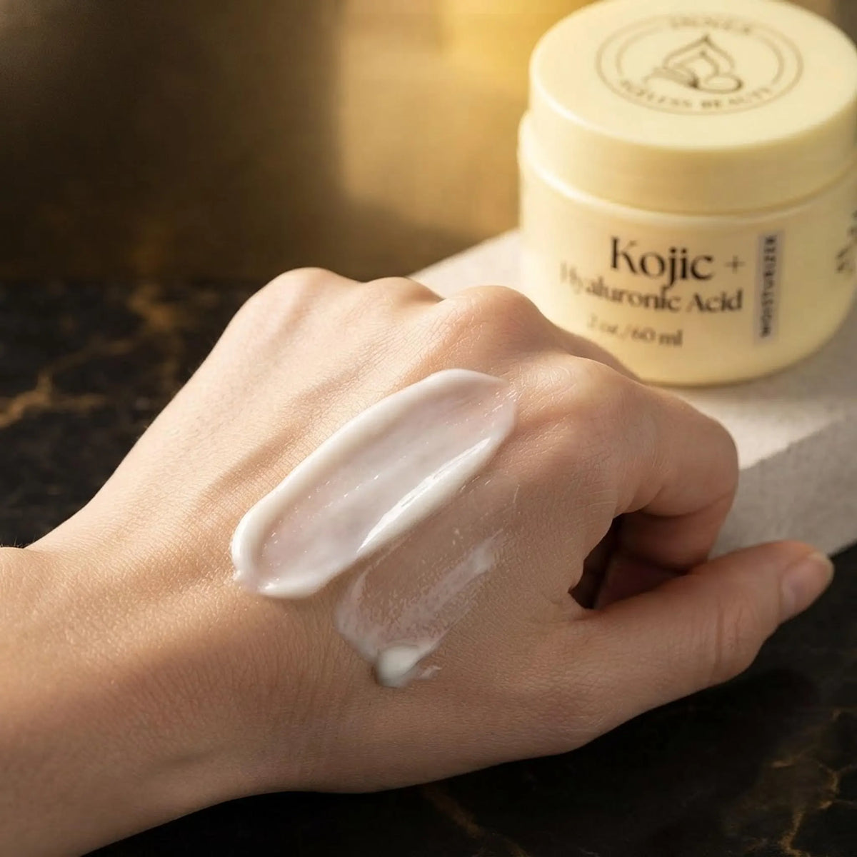 Close-up of rich white facial moisturizer cream swatched on skin showing smooth texture