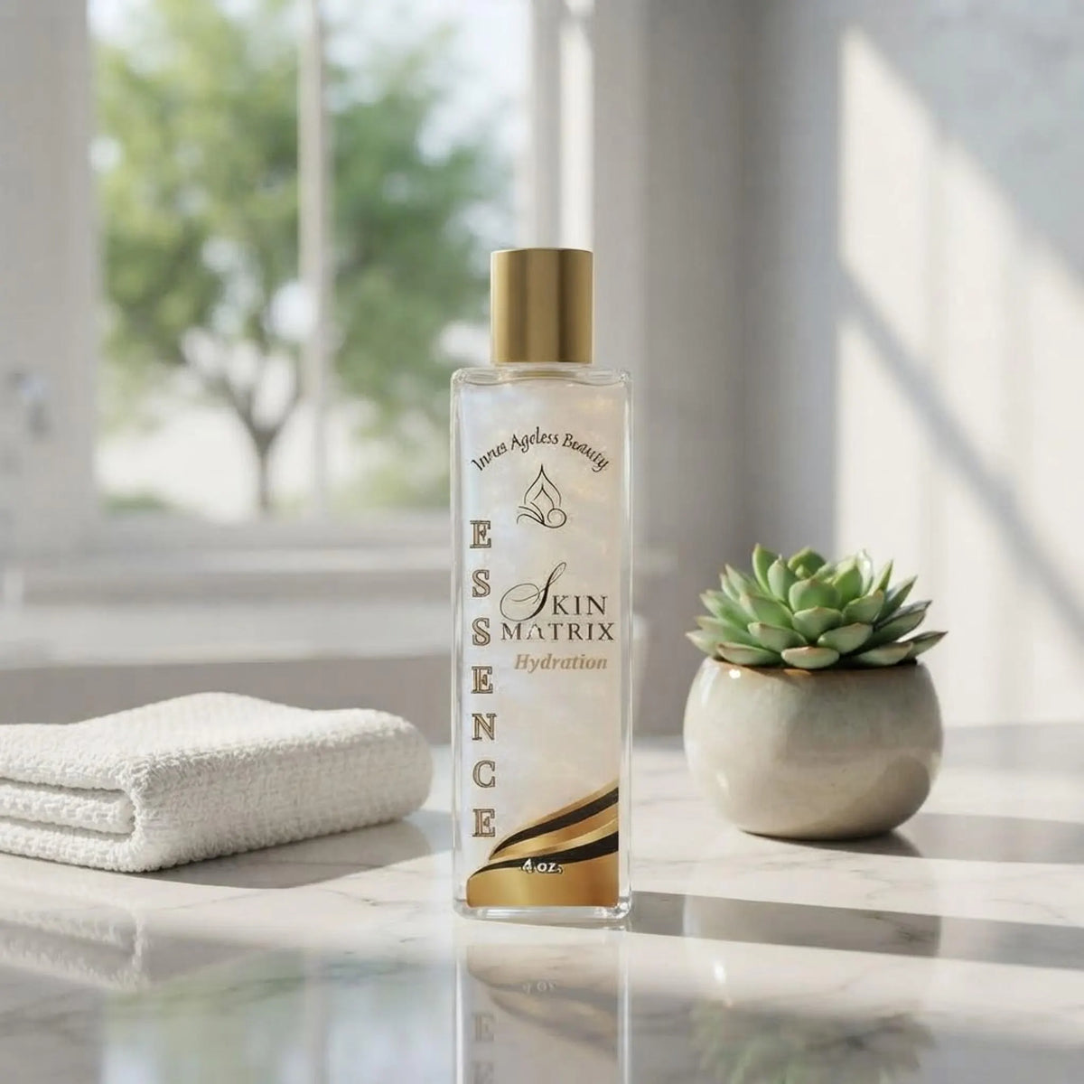 Innes Ageless Beauty hydration essence bottle displayed on a bright marble bathroom vanity with a towel and plant.