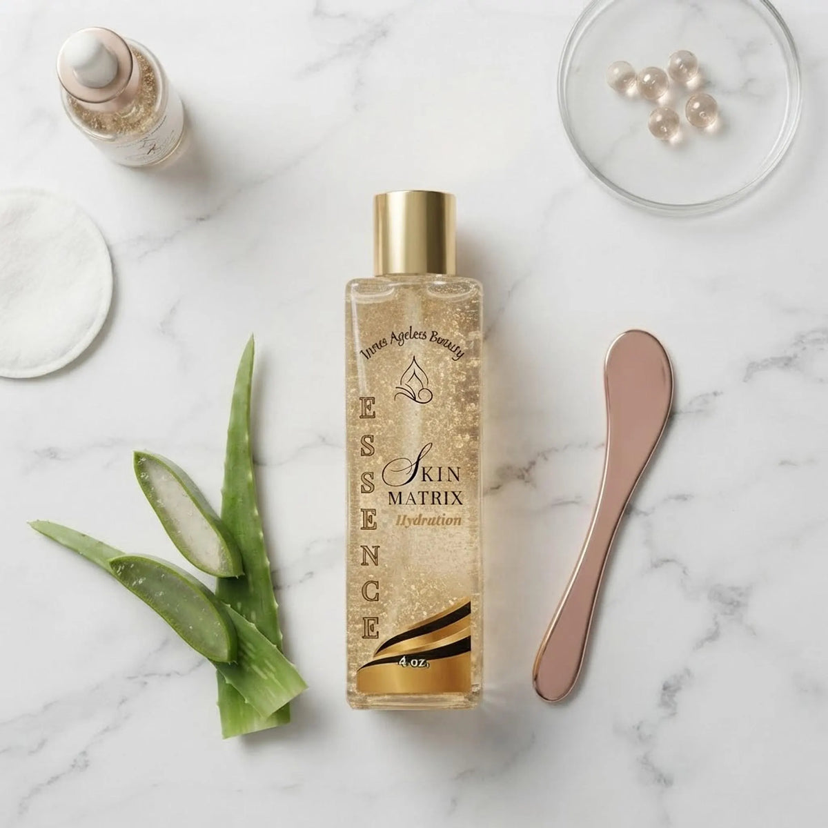 Flat lay of the hydration essence bottle with fresh aloe leaves on a white marble background.