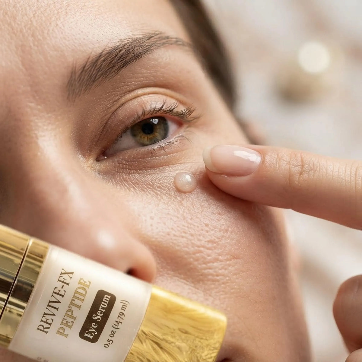 Close-up showing the lightweight ReviveFX Peptide Eye Complex serum being applied gently around the eye area