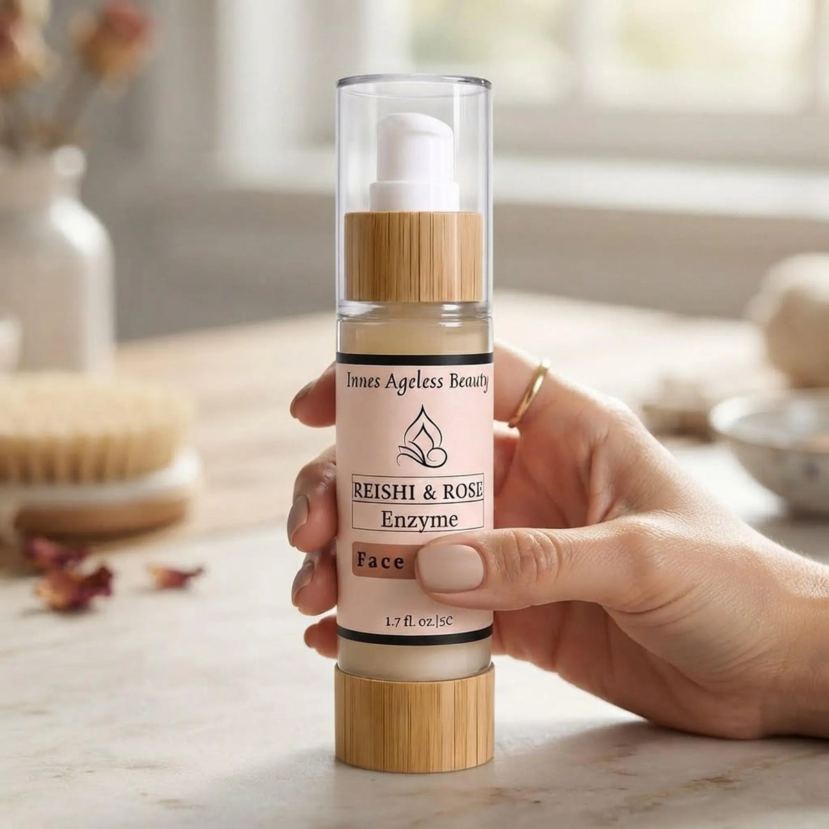 Person holding the Innes Ageless Beauty Reishi & Rose Enzyme Face Serum bottle to show size and scale