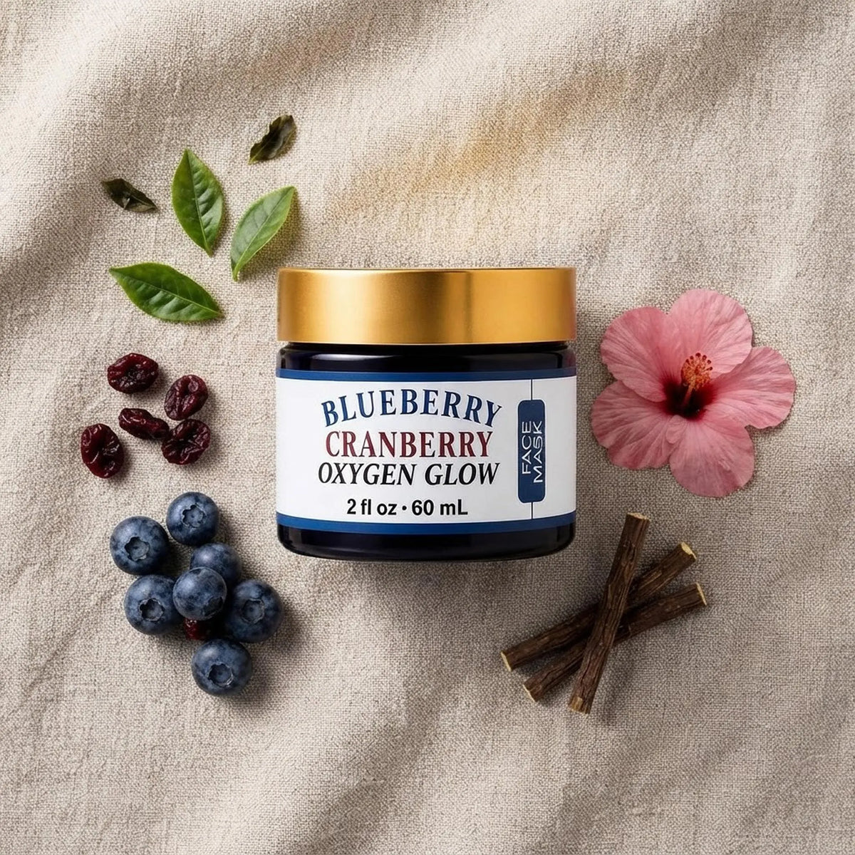 Overhead flat lay of the face mask jar surrounded by fresh blueberries, cranberries, and botanical leaves.