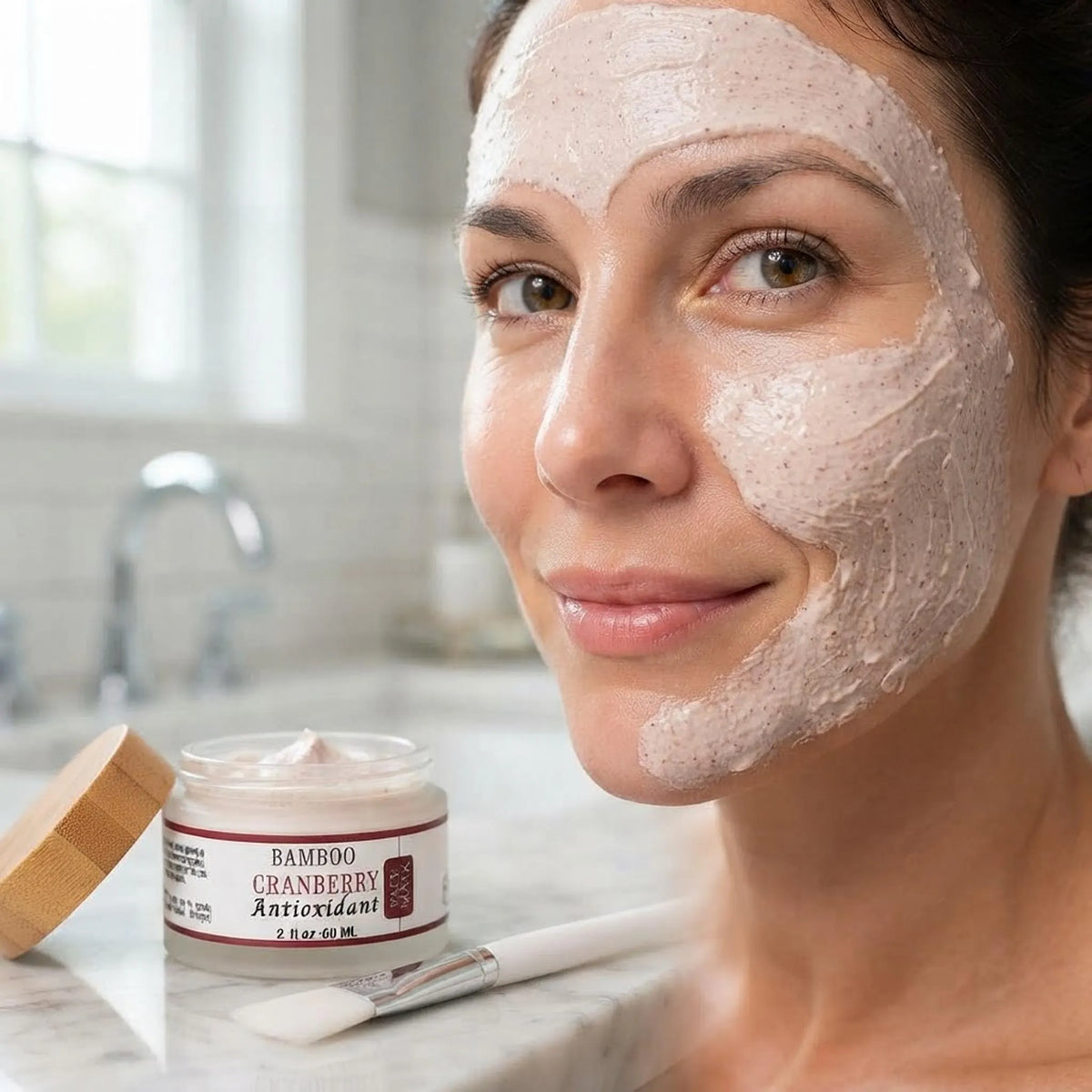 Close-up of a woman with the Bamboo Cranberry Antioxidant Face Mask applied evenly on her face.