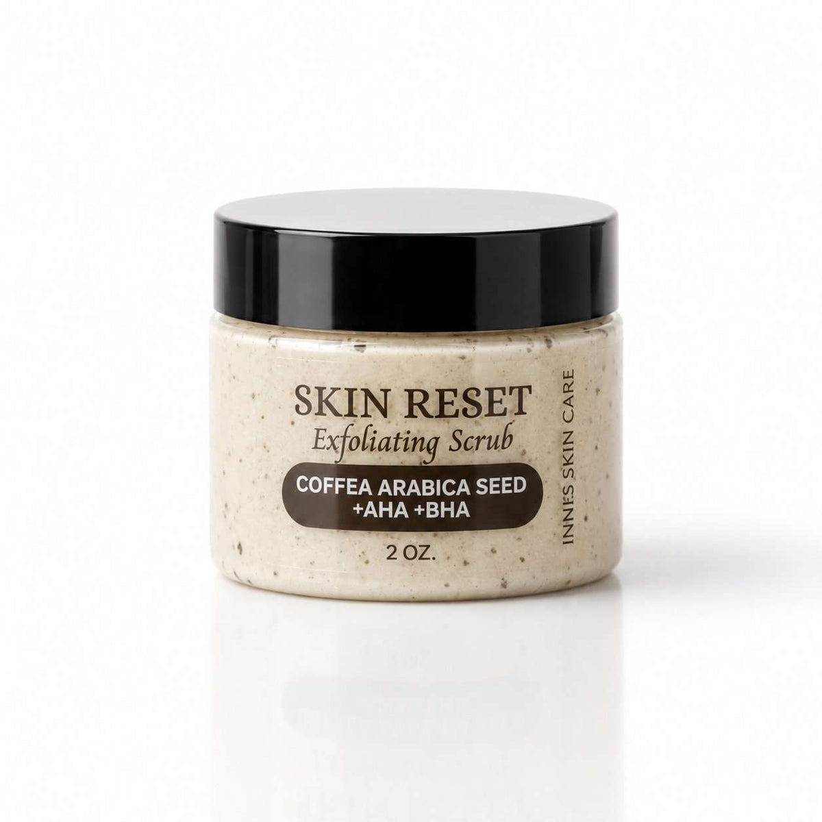 Skin Reset Coffea Arabica exfoliating face scrub in a cream-colored jar with a black lid and speckled formula